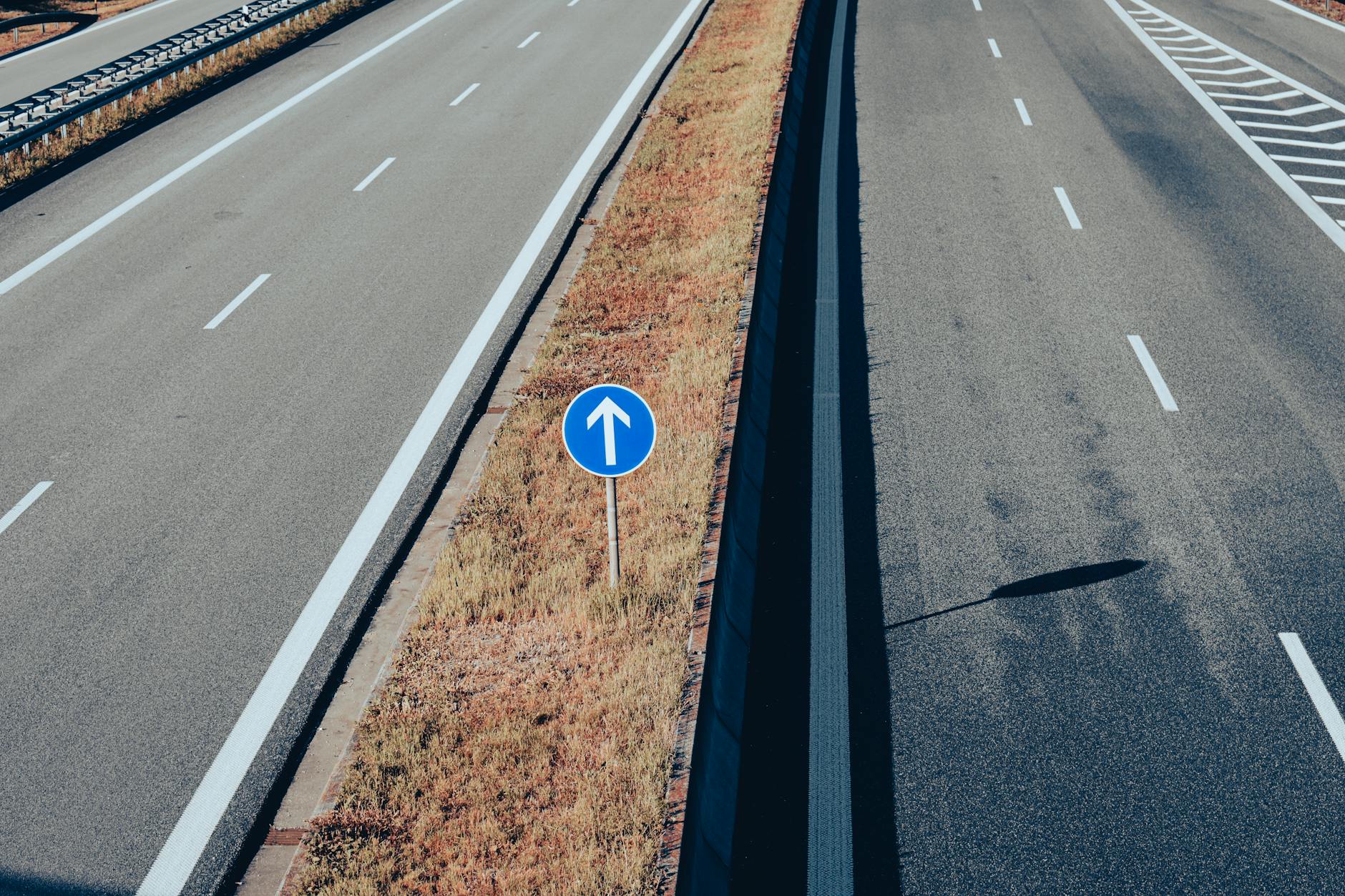 Pusty odcinek drogi ekspresowej z widocznym znakiem kierunku jazdy